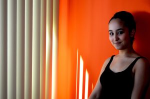 top-window-coverings girl by window blinds